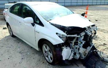 Front-end accident damage on a white Prius